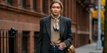 Celebrity in chic layered fall outfit walking urban street