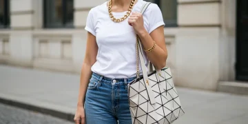 Woman elevating a basic outfit with a chunky gold necklace and oversized tote