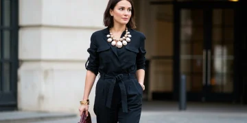 Woman in a minimalist outfit with a striking statement accessory